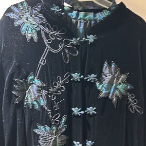 Black velvet coat with appliqués with bead trim & a plaid green silk shirt.
